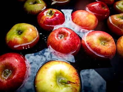 red and yellow apples floating on water apple pie teams background