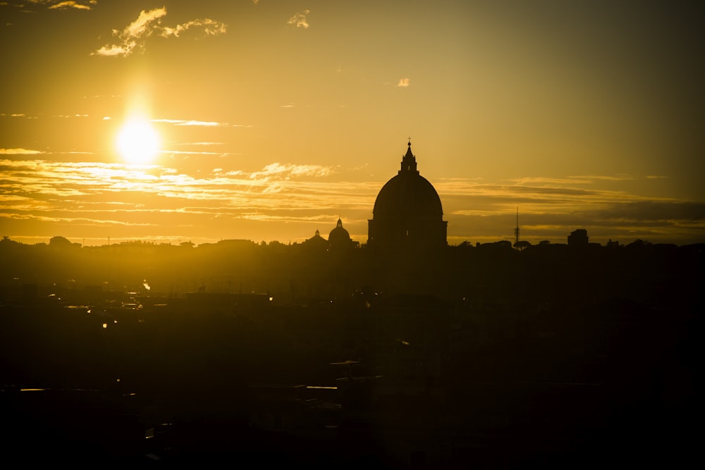 silhouette of dome building during sunrise