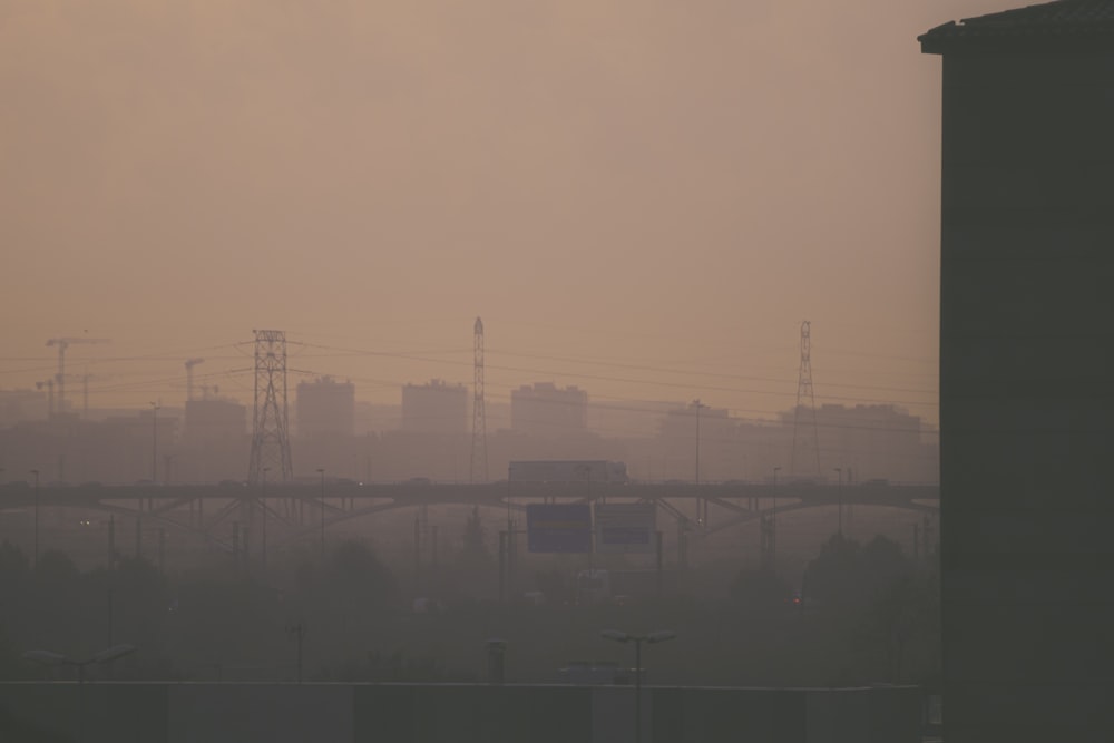 a hazy view of a city with power lines in the distance