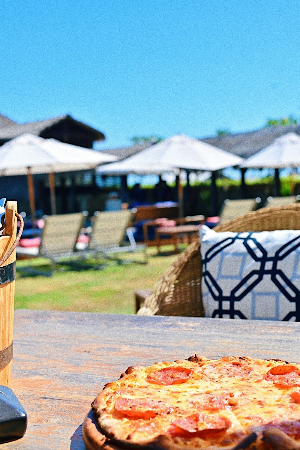 pepperoni pizza on top of outside table during clear blue sky