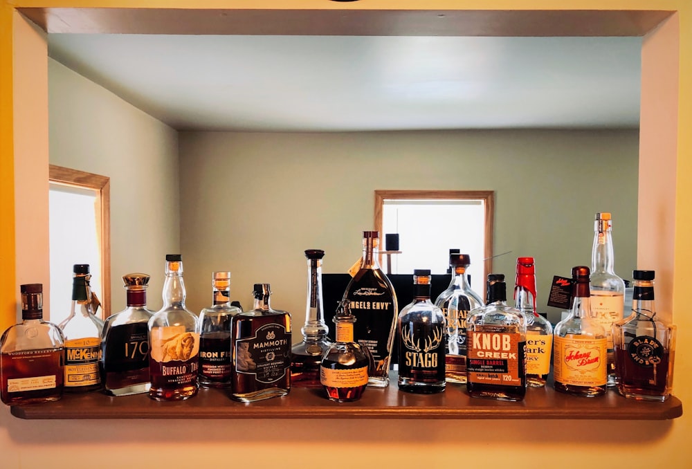 assorted liquor bottles on top of bar table