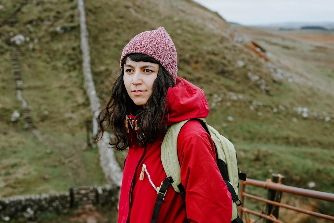 woman standing beside hill