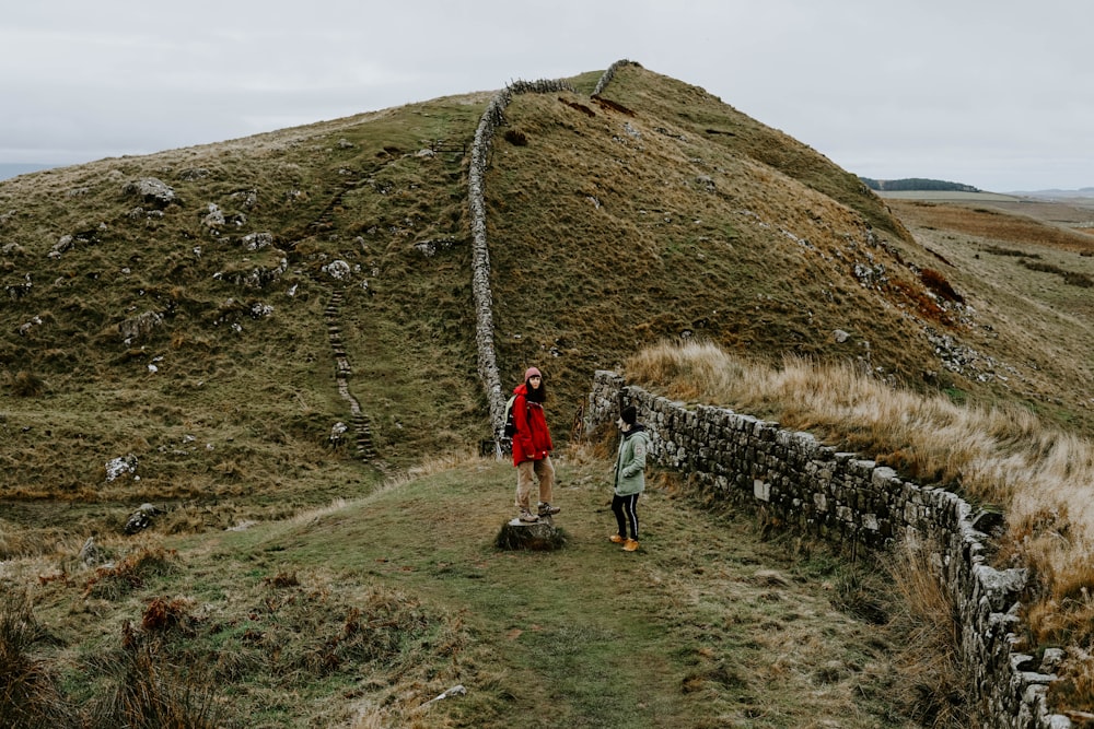 woman and man standing on grass field