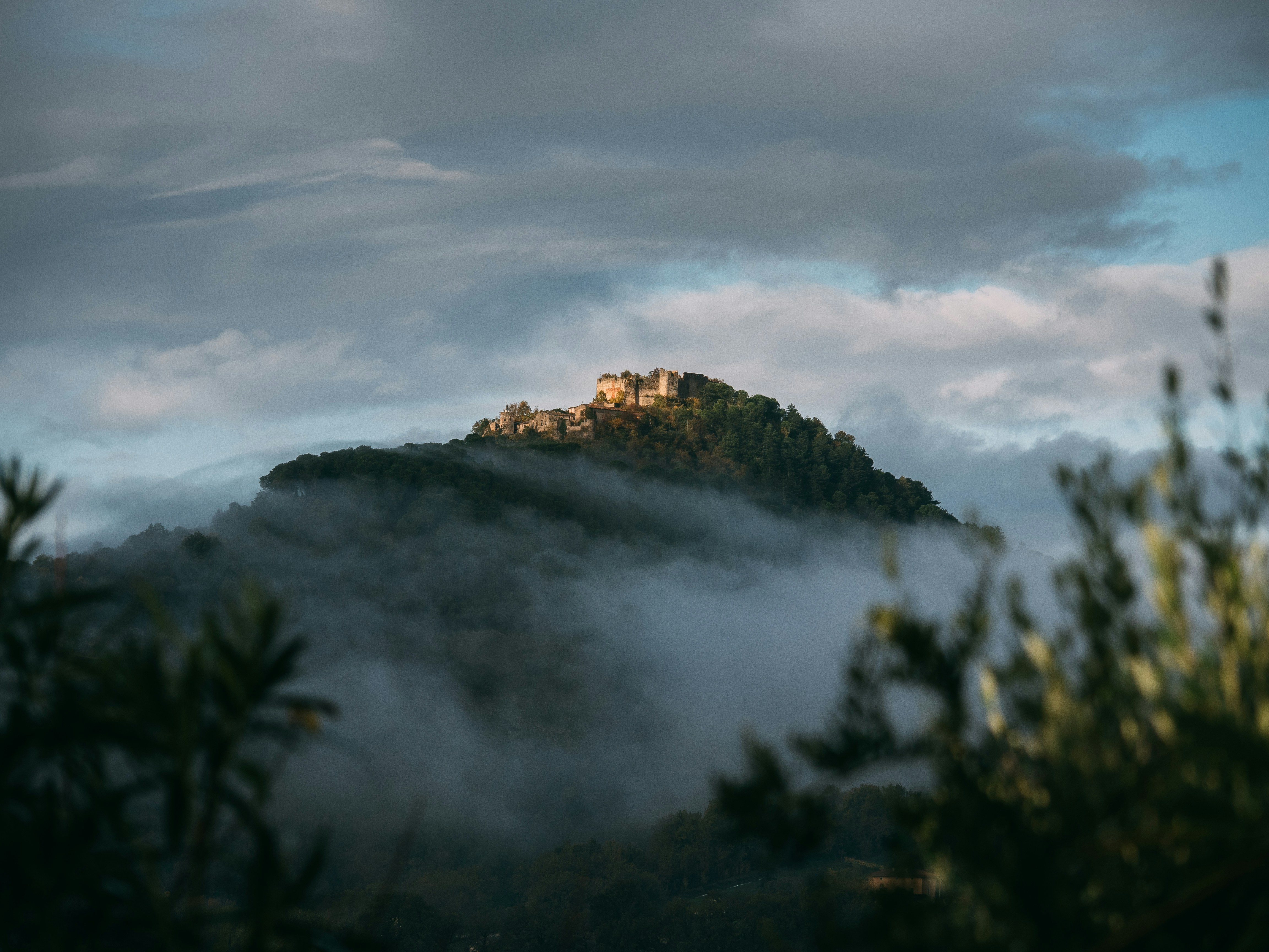in distant photo of mountain with sea of clouds