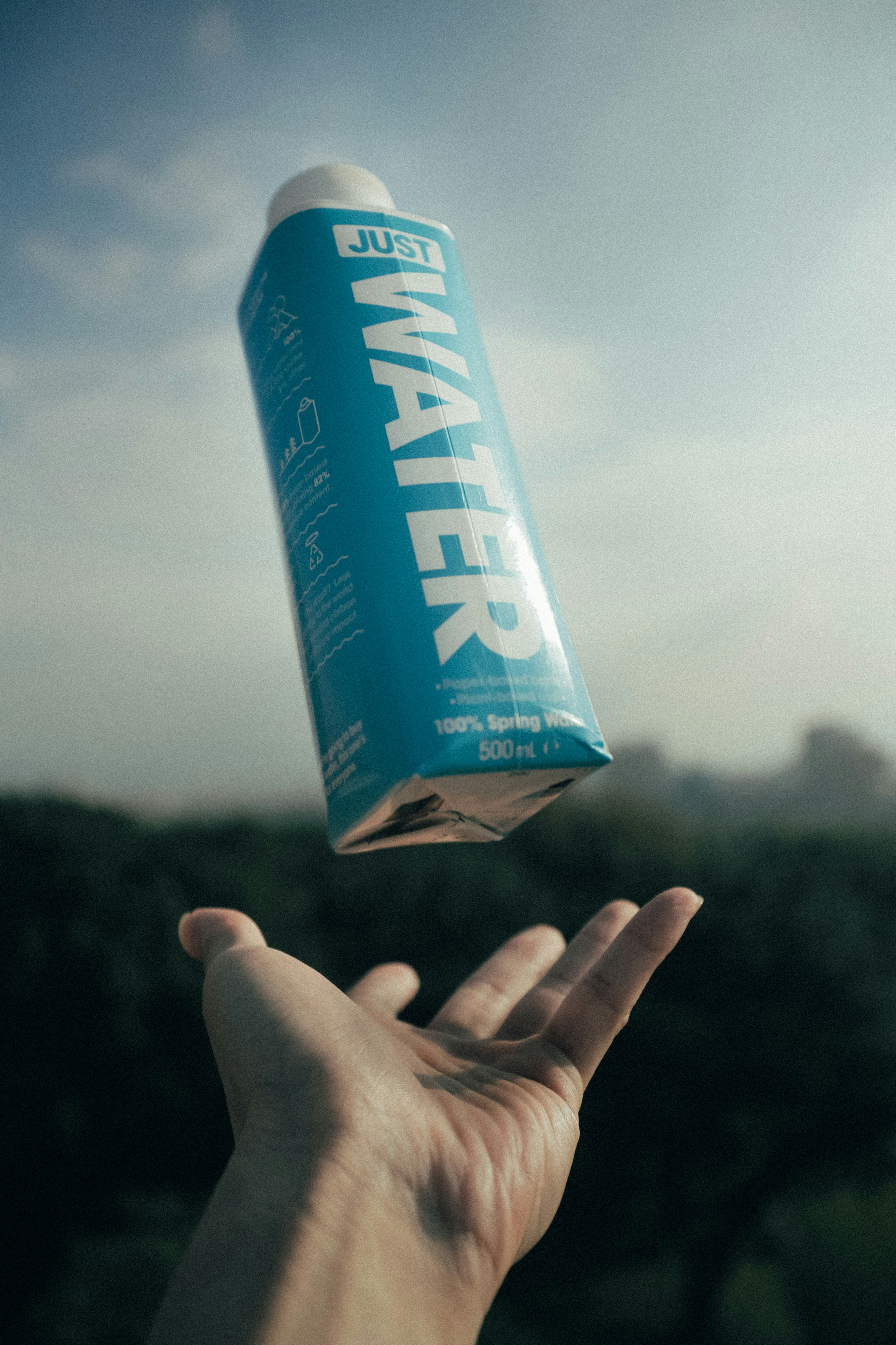 person throwing Just Water bottle photo Free Human Image on Unsplash