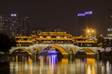 photography of building and bridge during nighttime