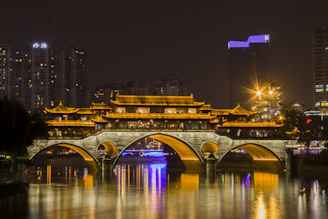 photography of building and bridge during nighttime