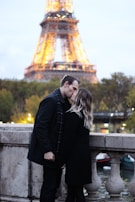 A couple sharing a kiss in front of a famous landmark.