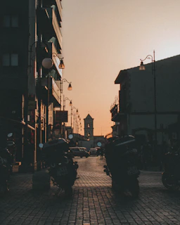 Historic cobblestone streets winding through an ancient town at dusk.