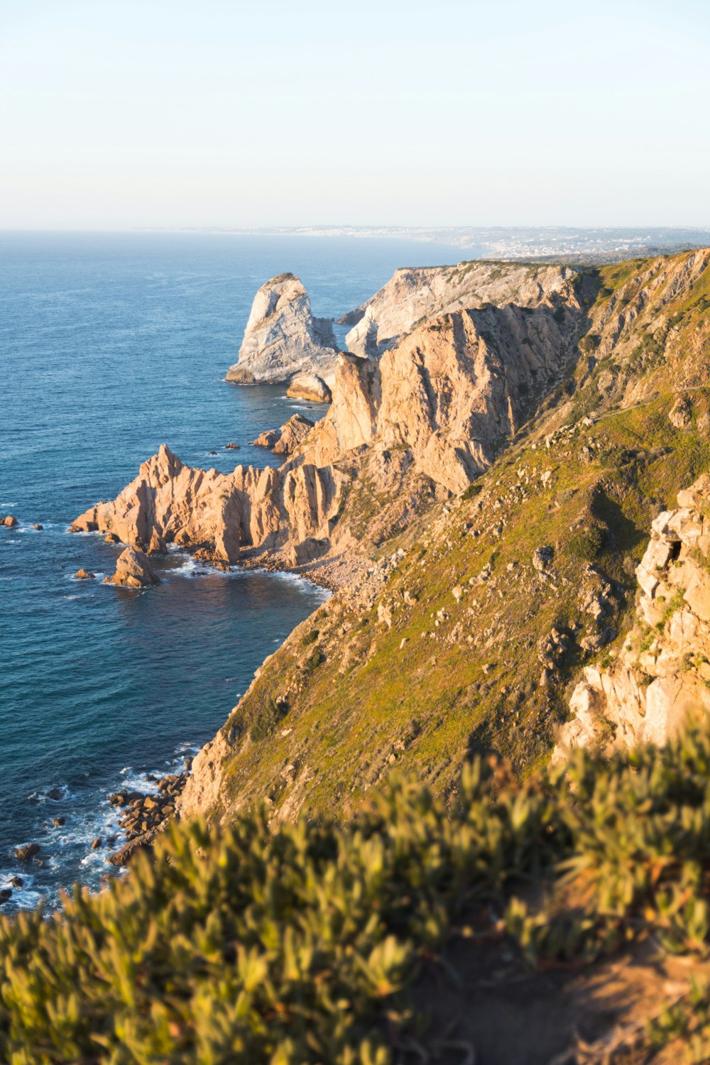 photography of mountain range beside seashore during daytime