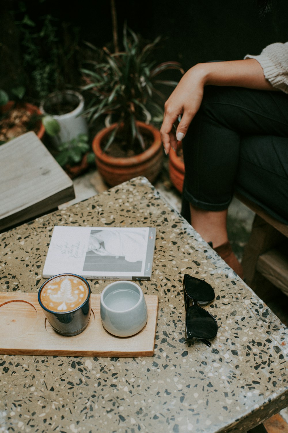 cup of frappe beside white ceramic mug on brown slab