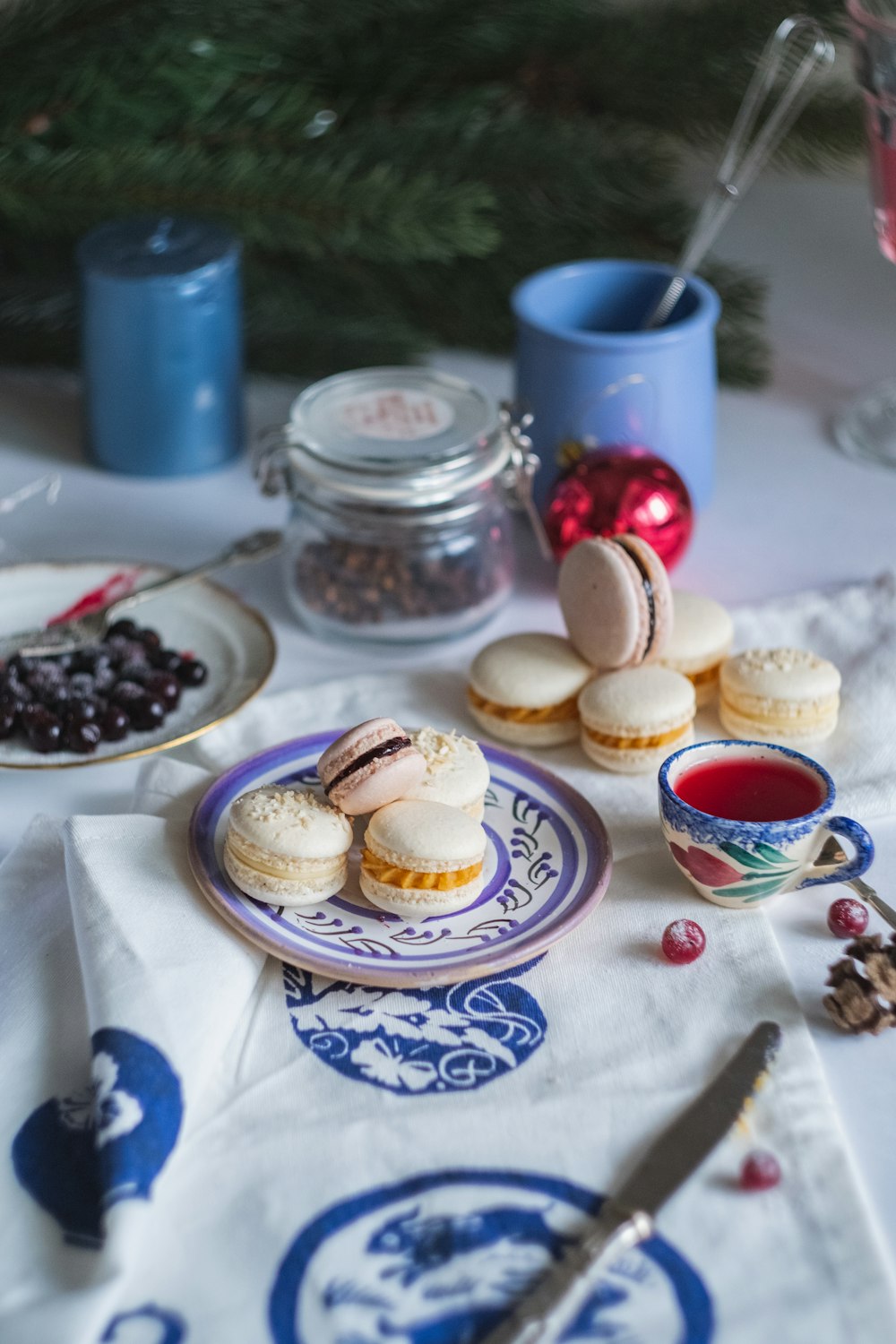 macarons on white and blue floral ceramic saucer