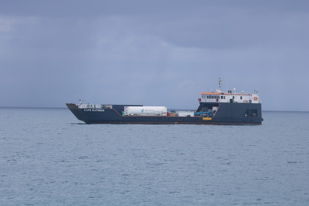 whtie and gray cargo ship in the midle of ocean