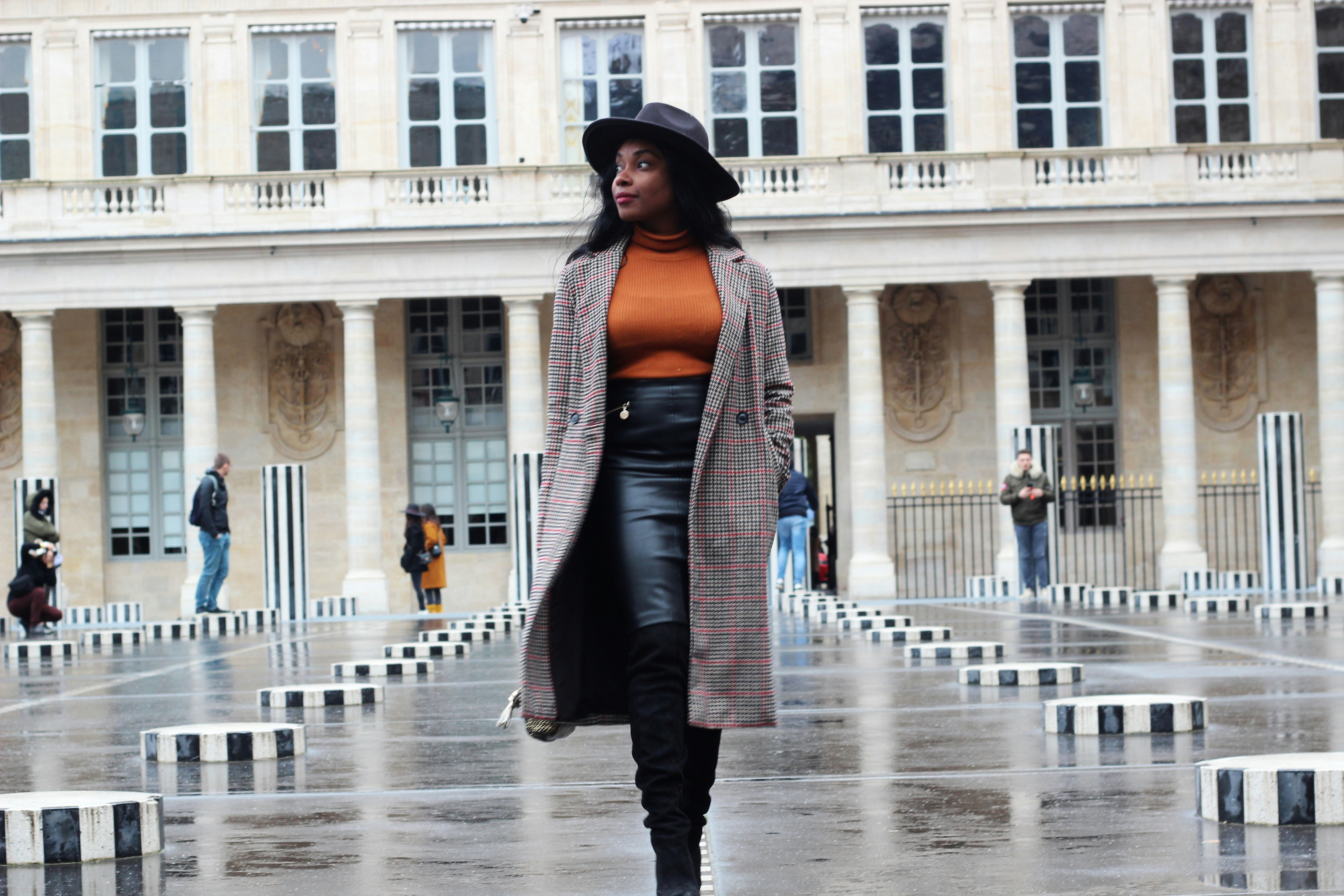 woman in brown jacket and gray skirt