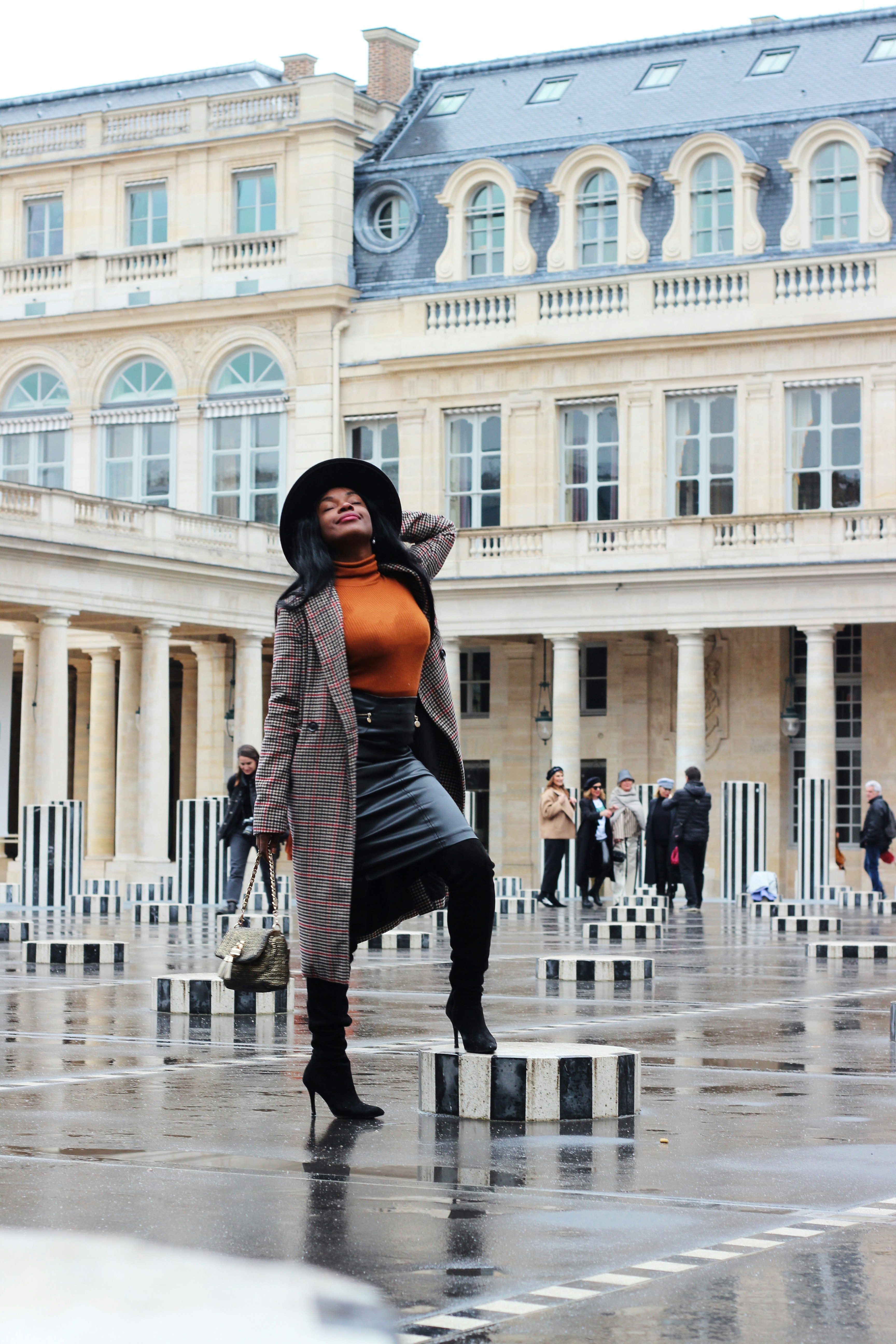 selective focus photography of standing woman near outdoor during daytime