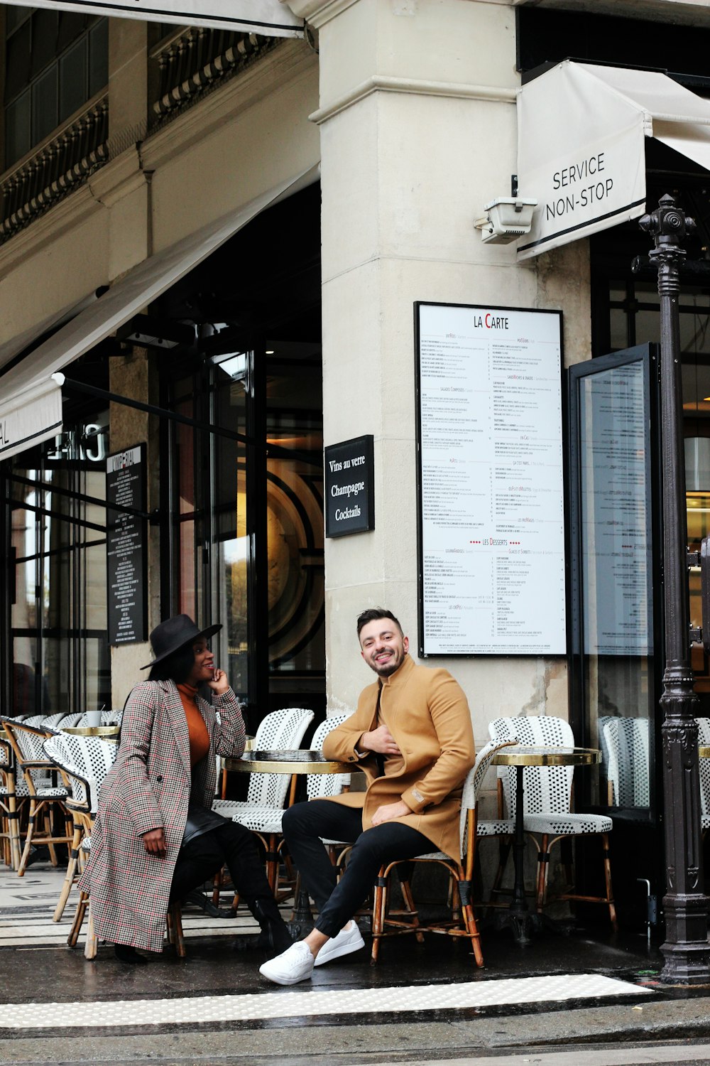 man and woman sitting in a coffee shop