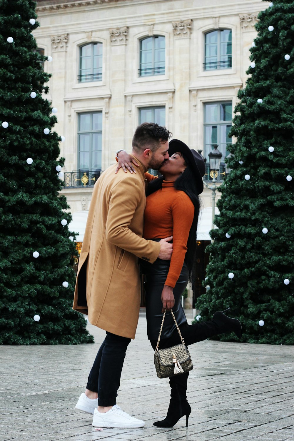 man and woman kissing on street