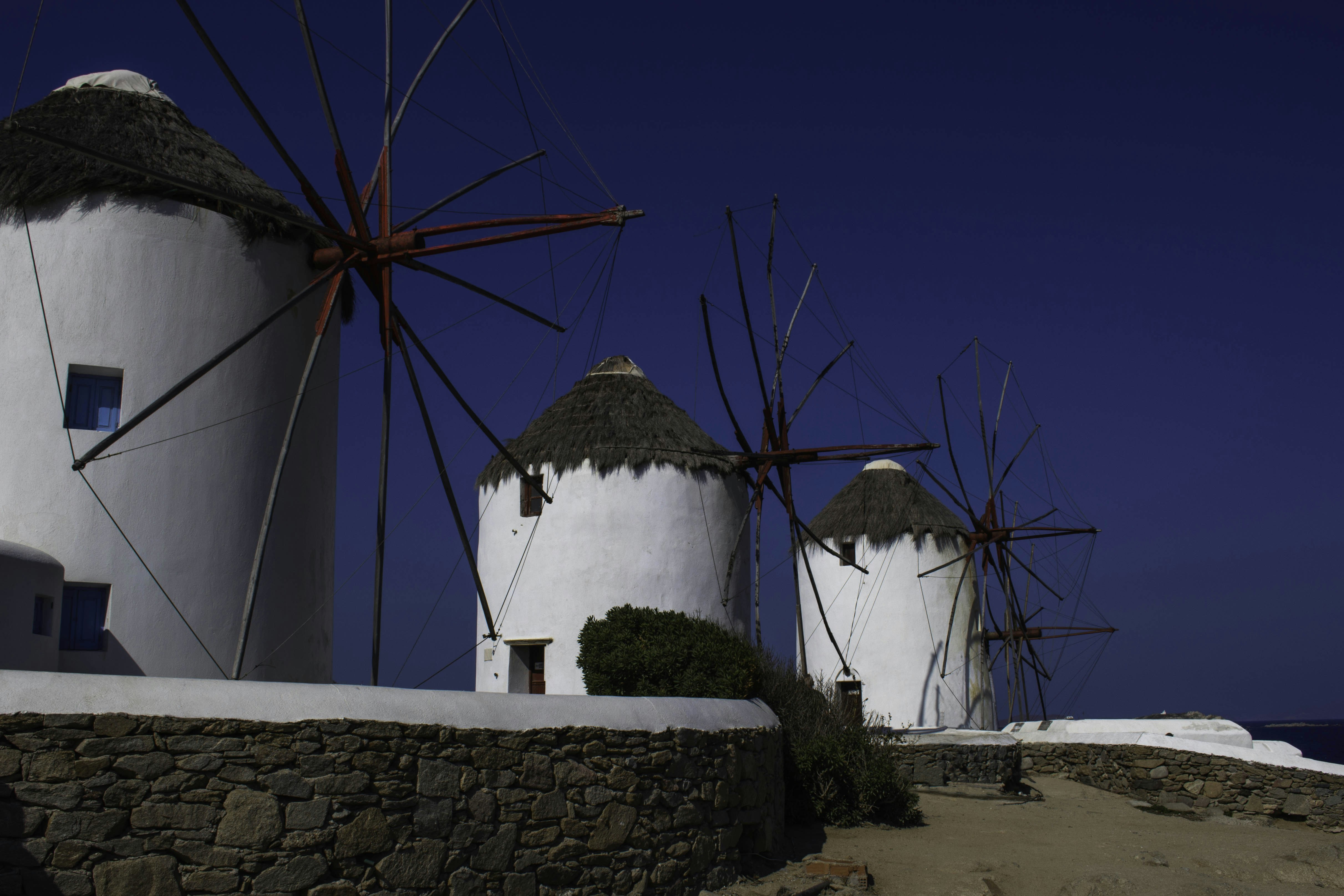 photo of concrete house with windmill