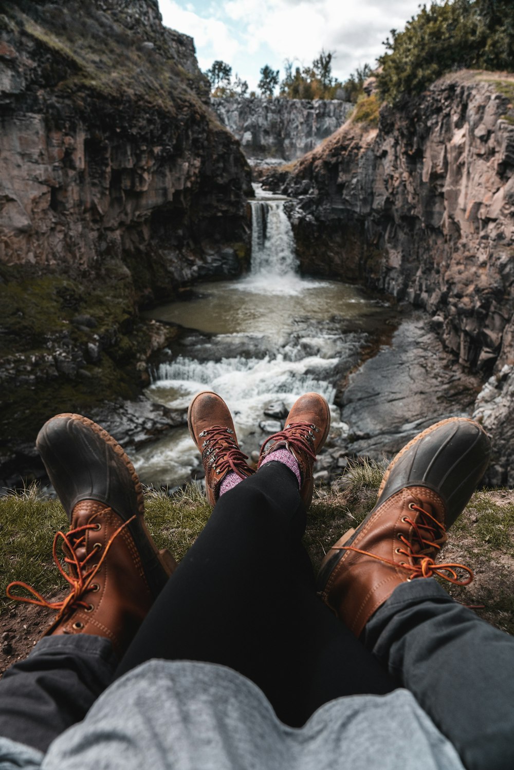 person siting near waterfalls