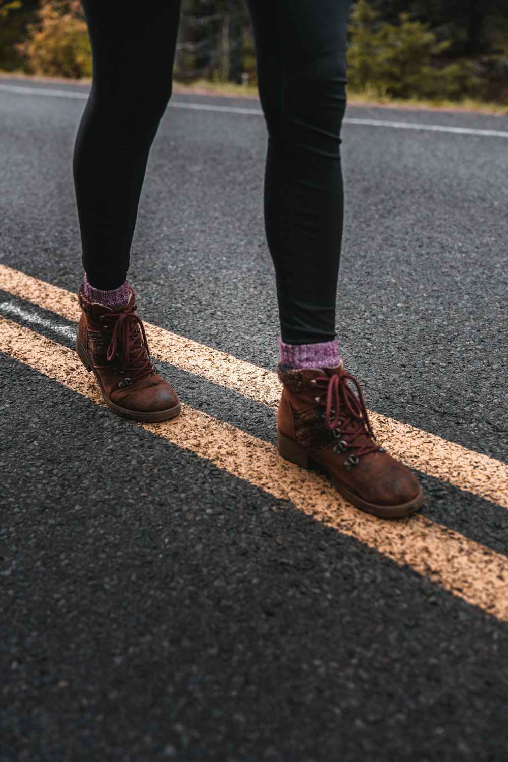 person wearing pair of brown leather boots