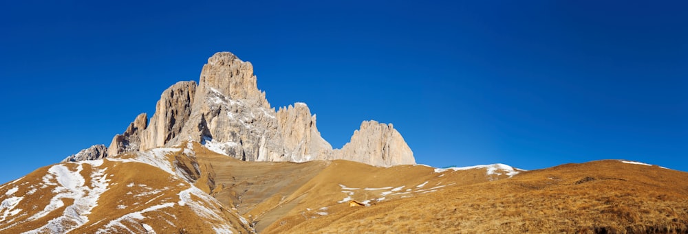 brown mountain under blue sky