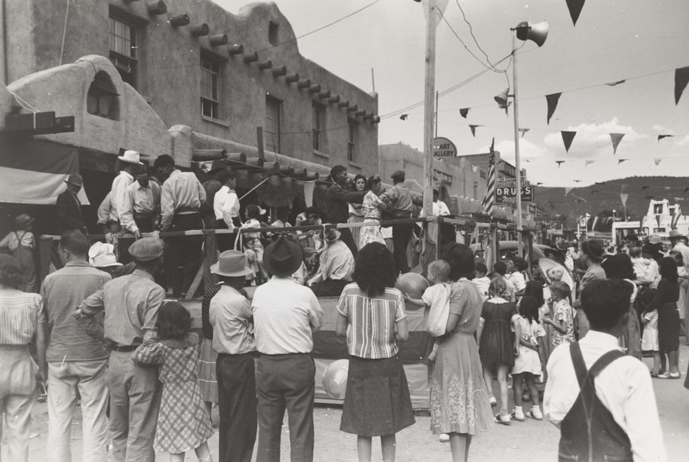 grayscale photo of people standing on stage