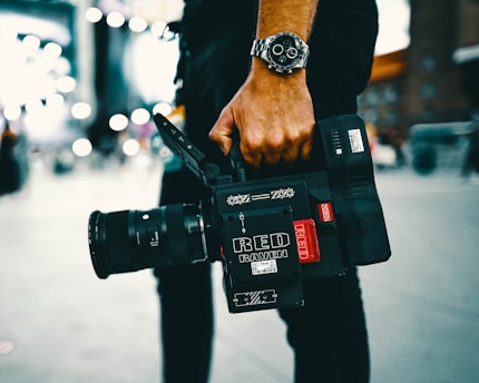 person holding black video camera