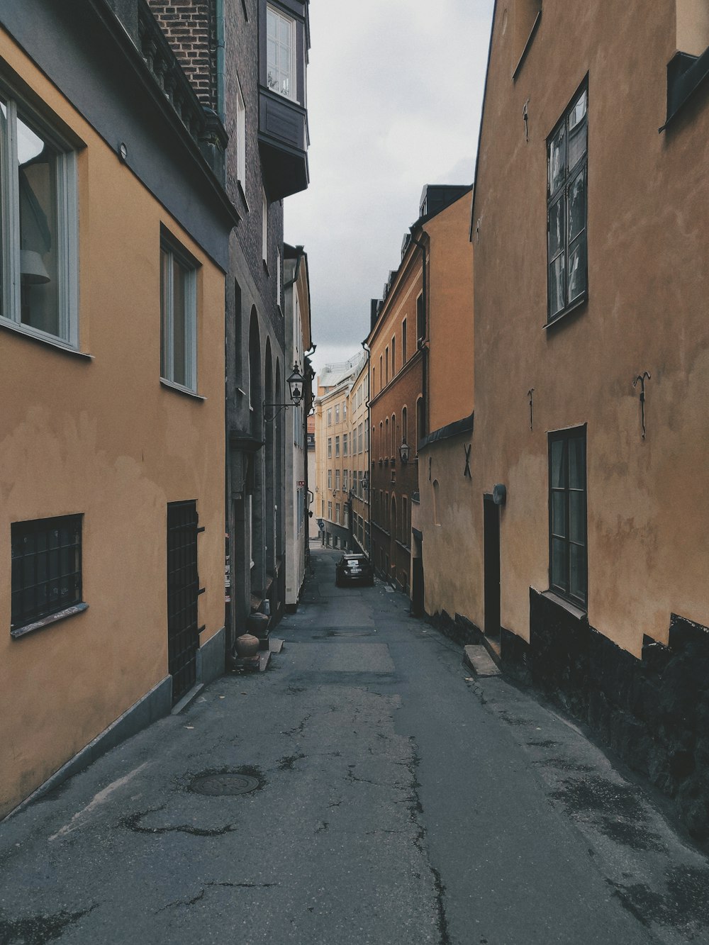 view photography of narrow road between buildngs