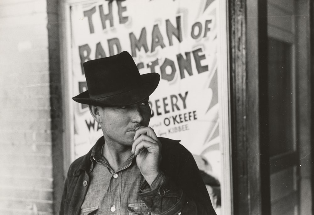 man looking at his left in front of building