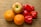 A close-up of fresh fruits and vegetables arranged beautifully on a wooden table.