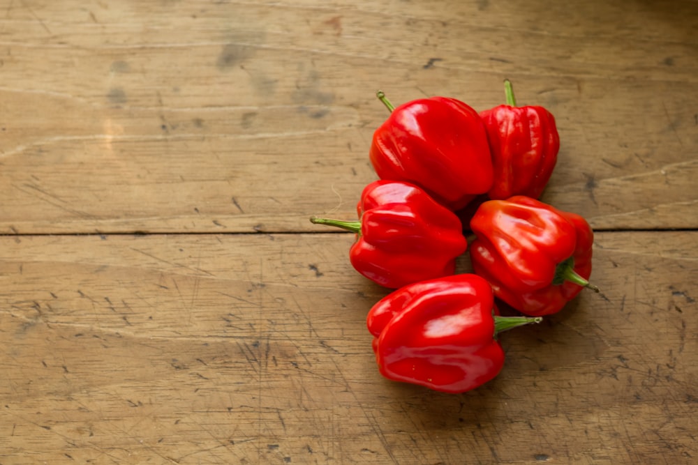 red bell peppers on brown surface