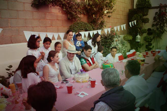 A picnic table adorned with American flags, plates piled high with hearty beef dishes, and cheerful friends celebrating.