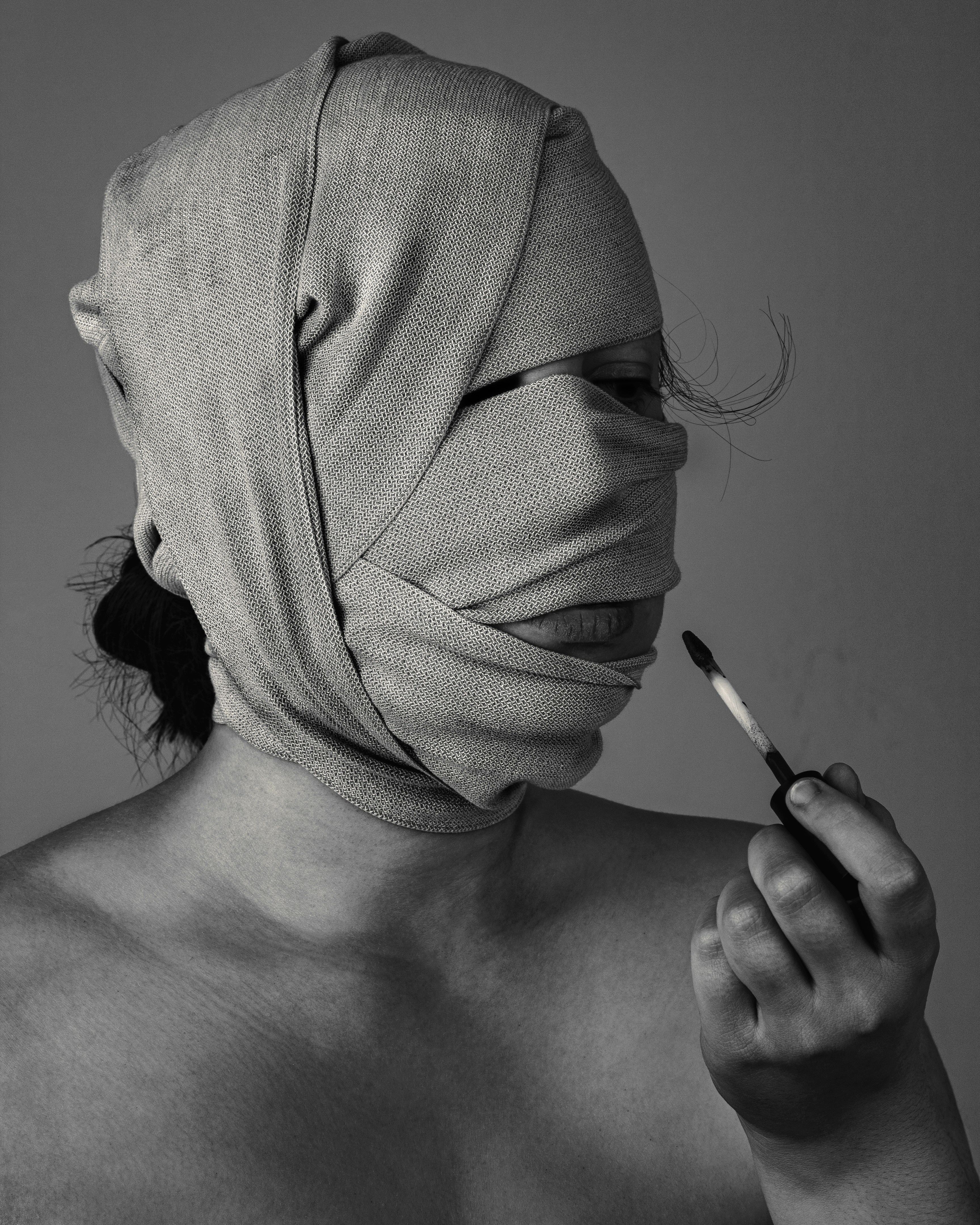 grayscal photo of woman with bandage on face