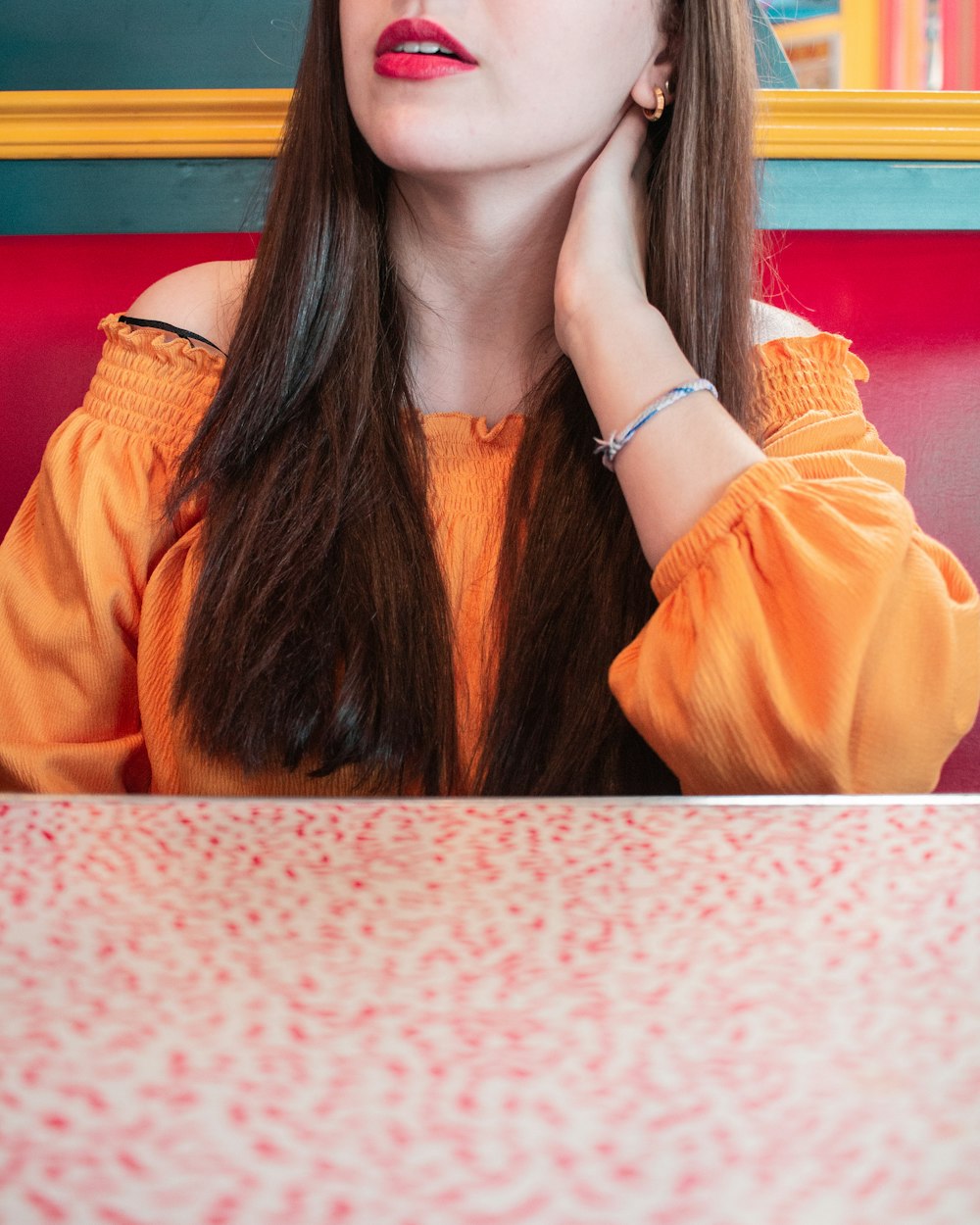 woman in orange off-shoulder blouse