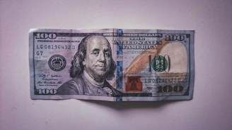 a hundred dollar bill folded into a piece of paper