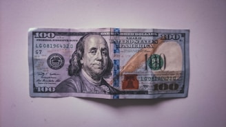 a hundred dollar bill folded into a piece of paper