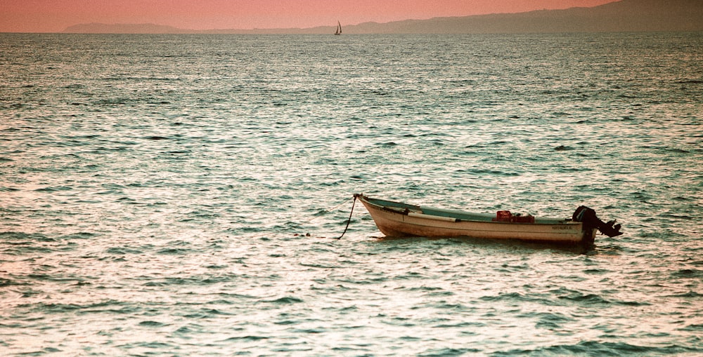 white rowboat on sea