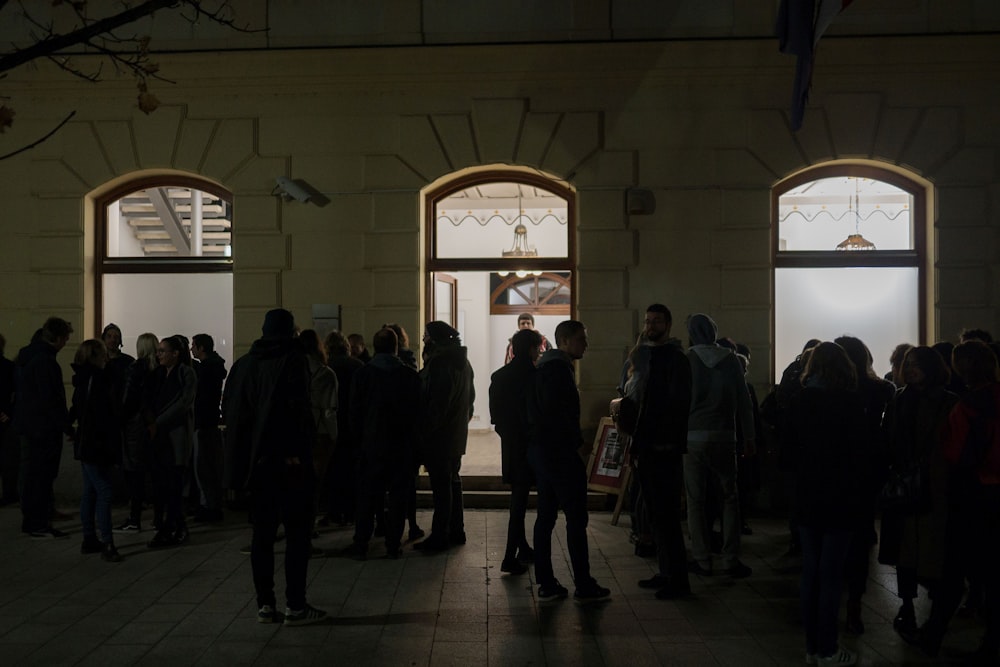 a group of people standing in front of a building