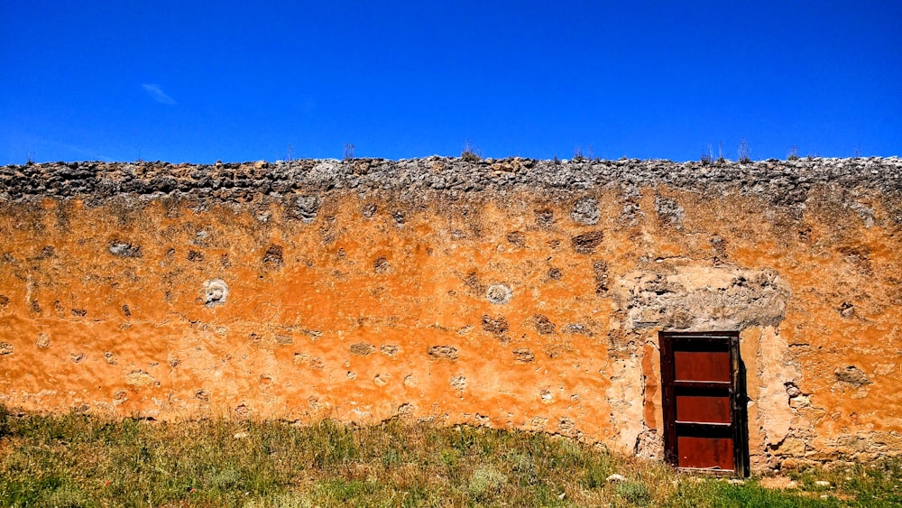 brown wall and red door