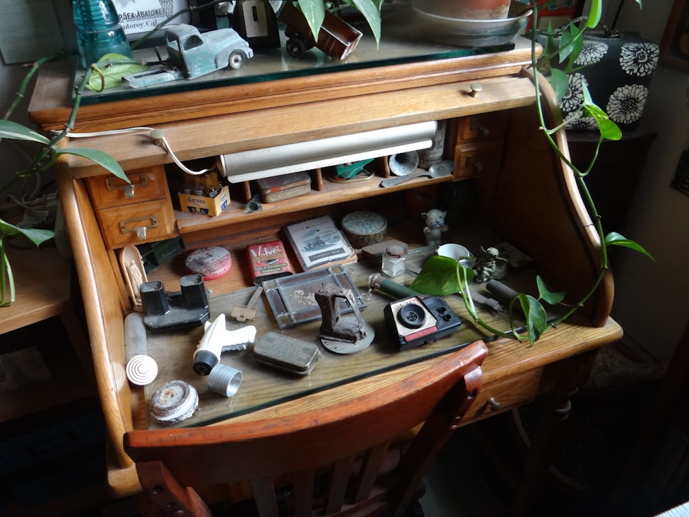 items on brown wooden roll-top desk