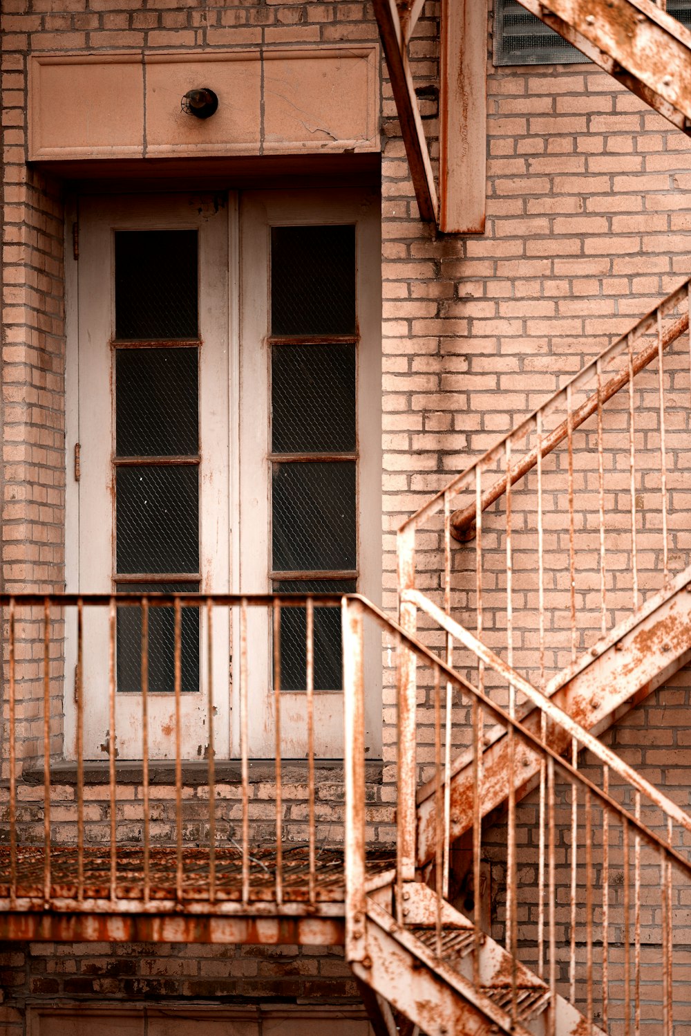 closed French doors beside stairs during day