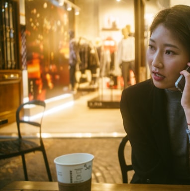 woman talking on phone outdoor in front of store