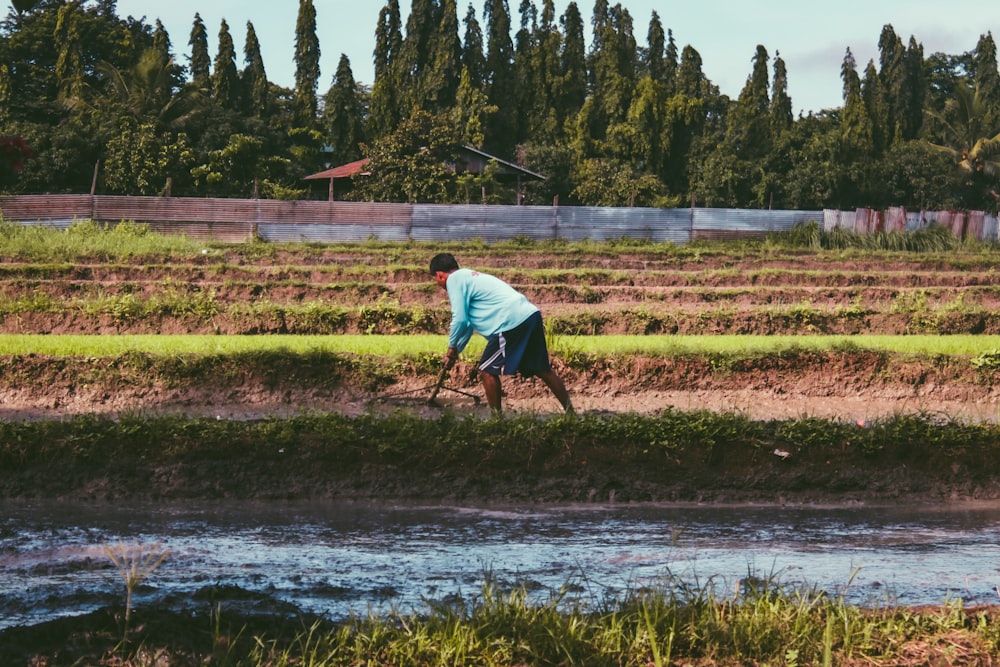 man farming on plant field during day