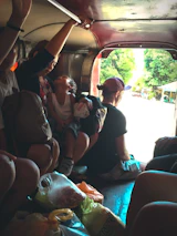 A happy family comfortably seated inside a spacious Nusantara Rent MPV during a trip.