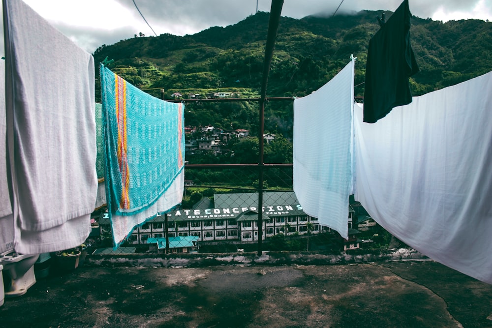 assorted-color blanket and towels hanged on cables