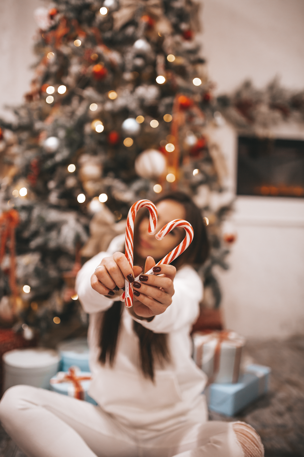 woman holding candy canes