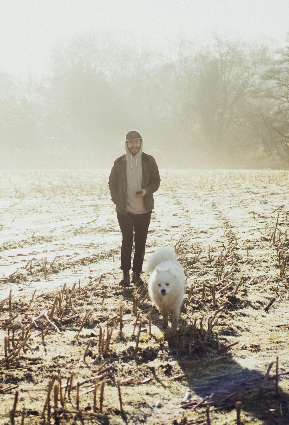 man near to white dog