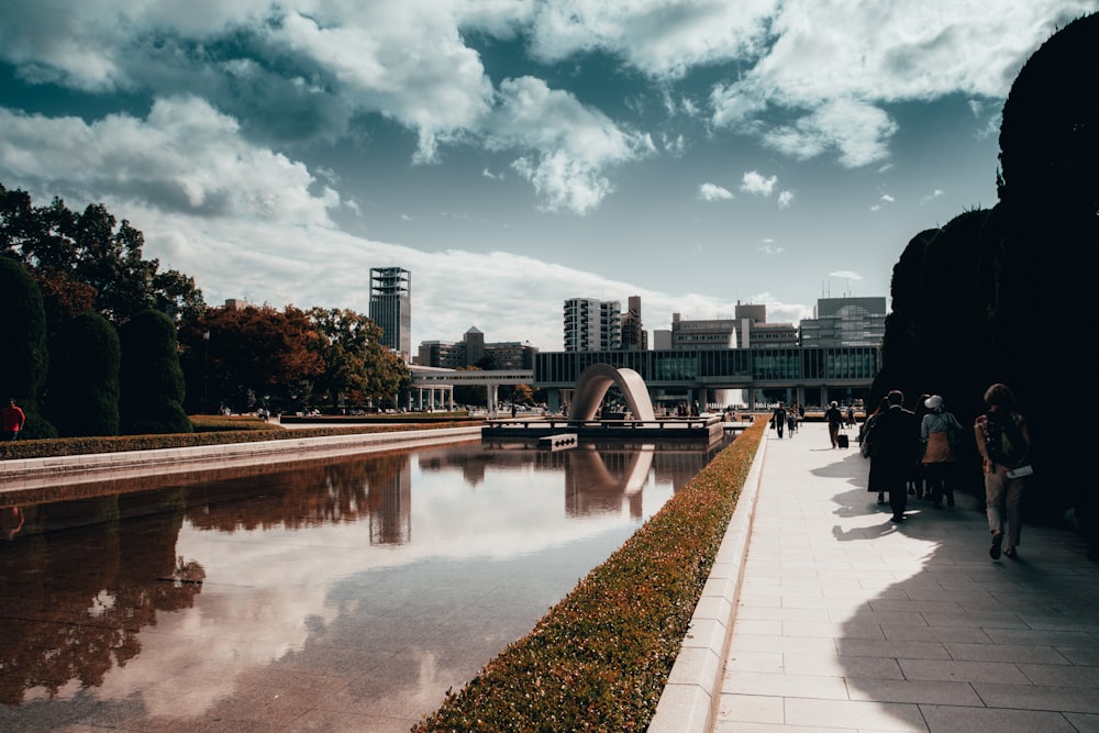 people walking on sidewalk near river