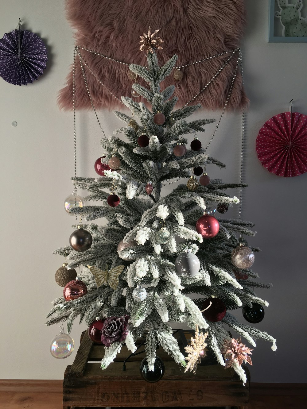 green Christmas tree with assorted-colored baubles and decorations