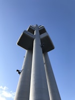 A newly constructed climbing tower standing tall against a clear blue sky.